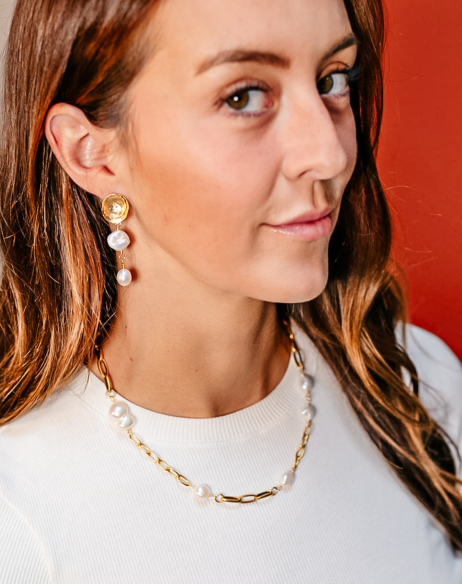 a model wearing keshi pearl earrings