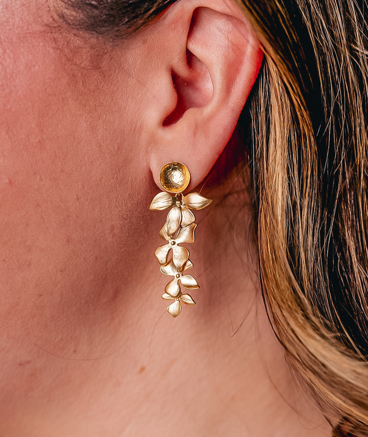 A model wearing a cascading orchid earring