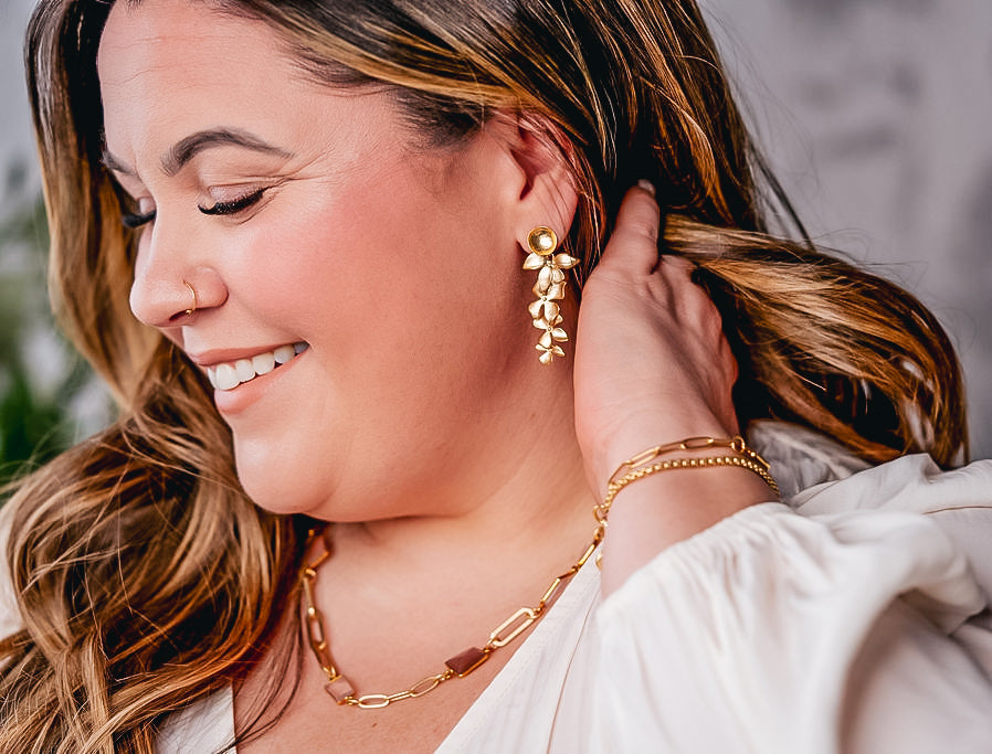 A model wearing a cascading orchid earring