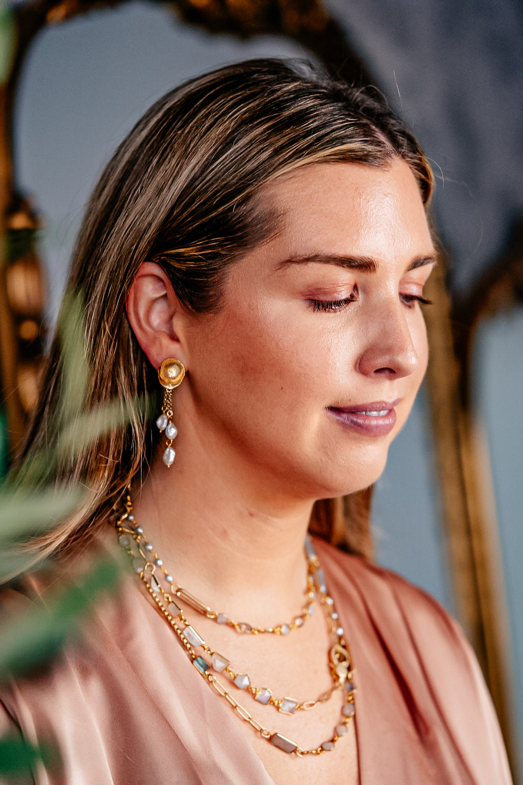 a model wearing a three strand rice baroque pearl earring