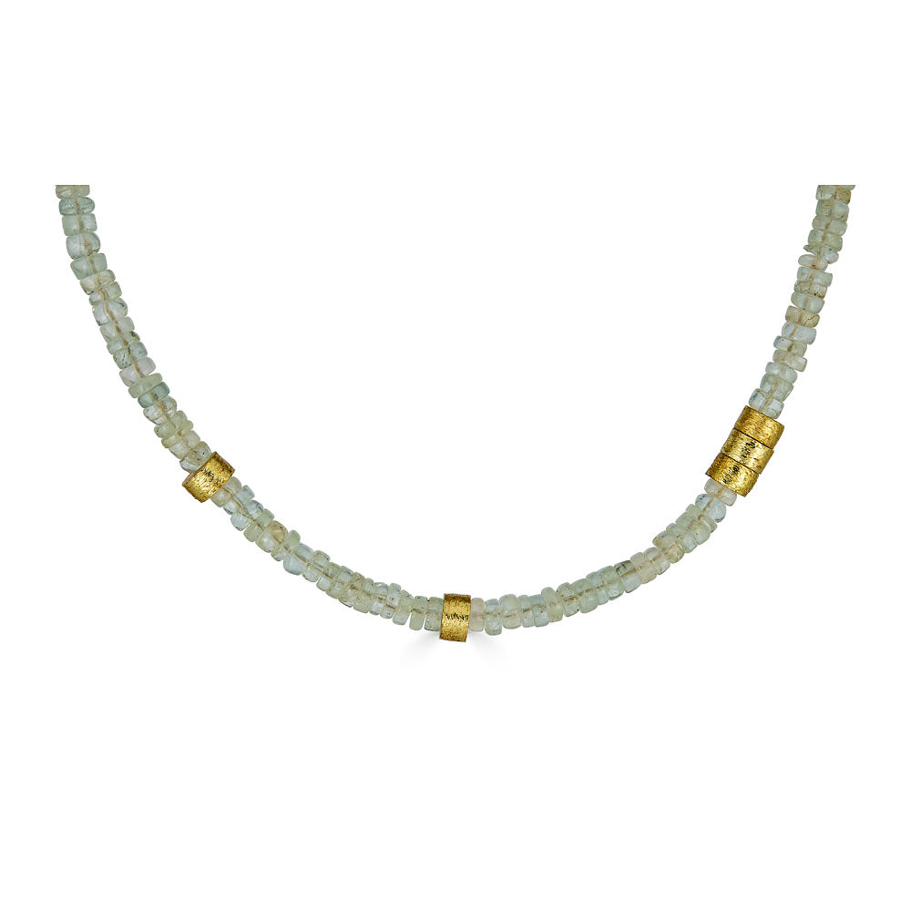 a gold aquamarine bead necklace with gold accents.