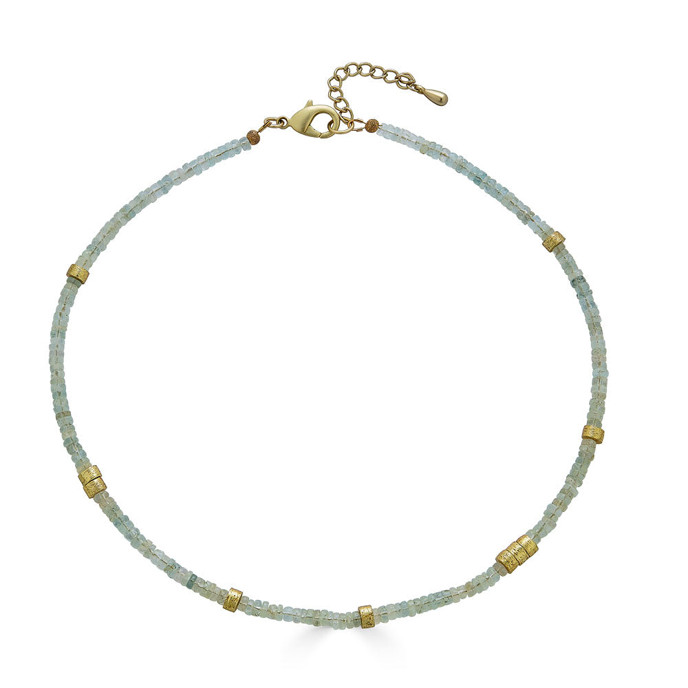 a gold aquamarine bead necklace with gold accents.