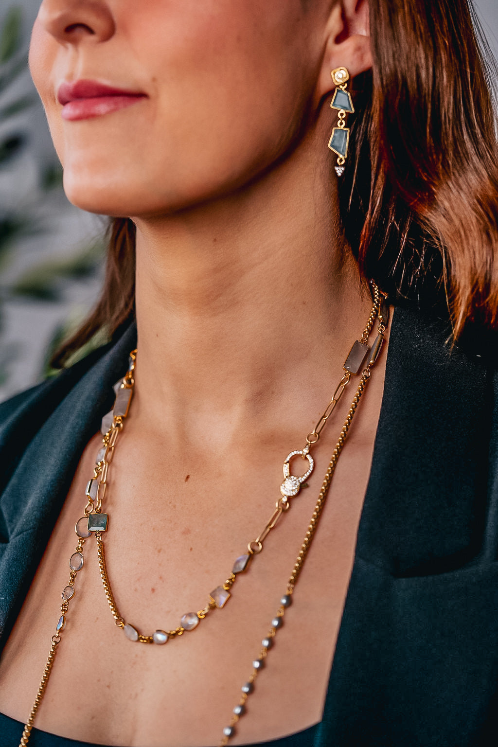 a model wearing aquamarine gold earrings