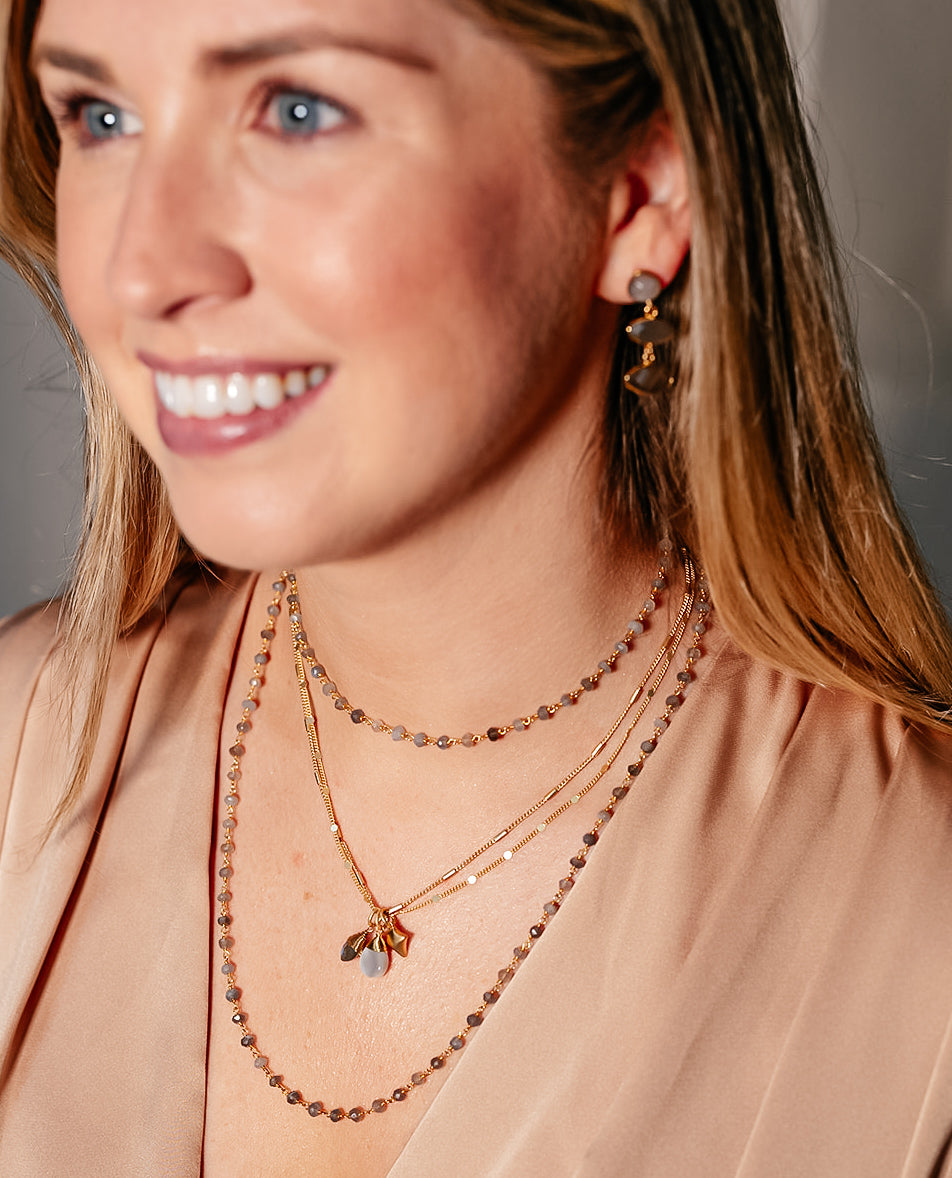 A model wearing marquis gray moonstone earrings