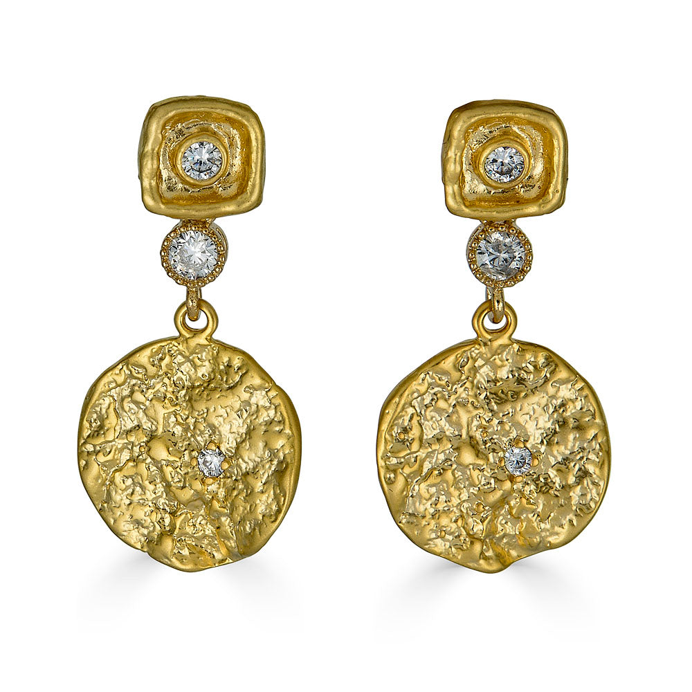 a gold hammered coin dangle earring.