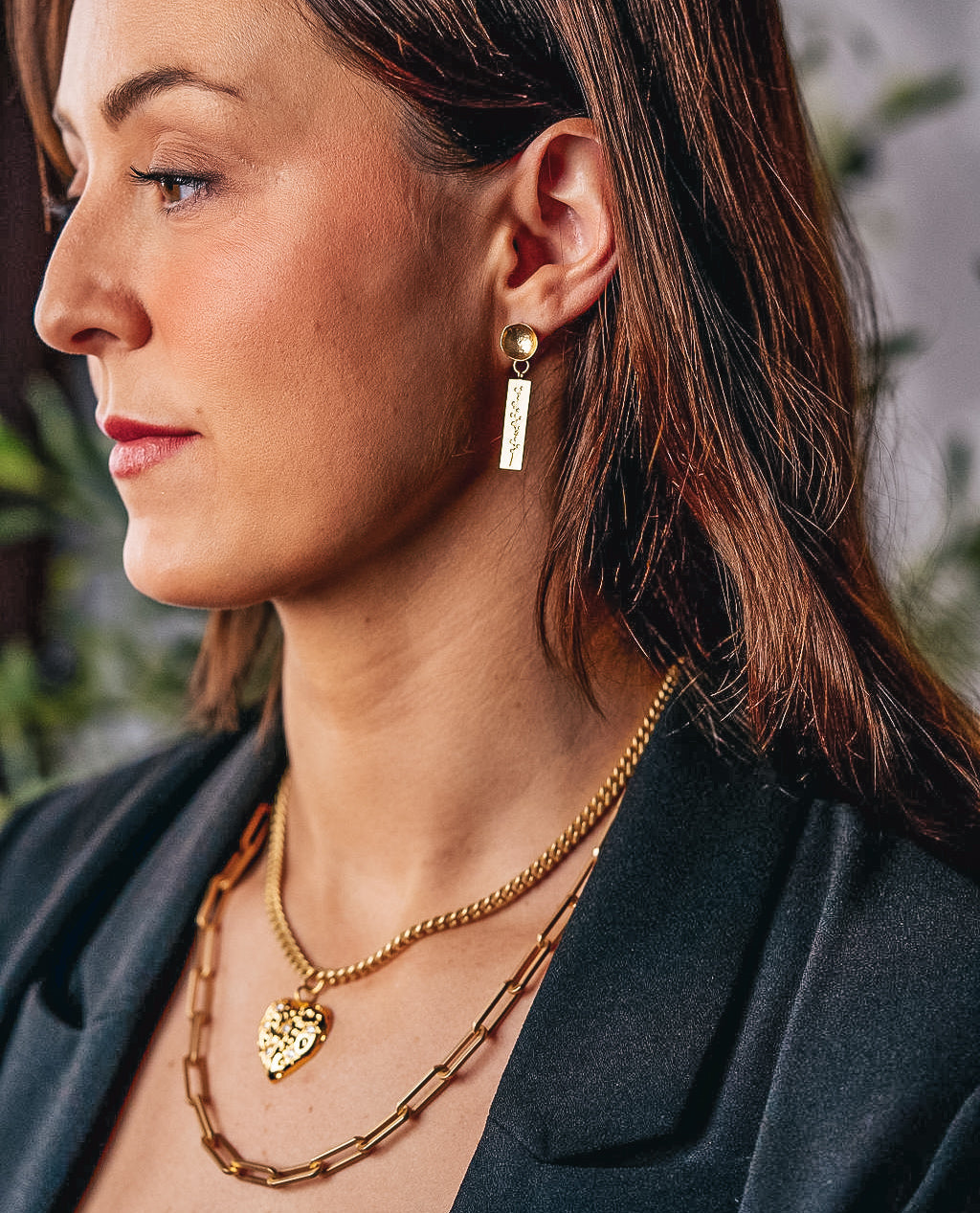 A model wearing a rectangle flower dangle earring