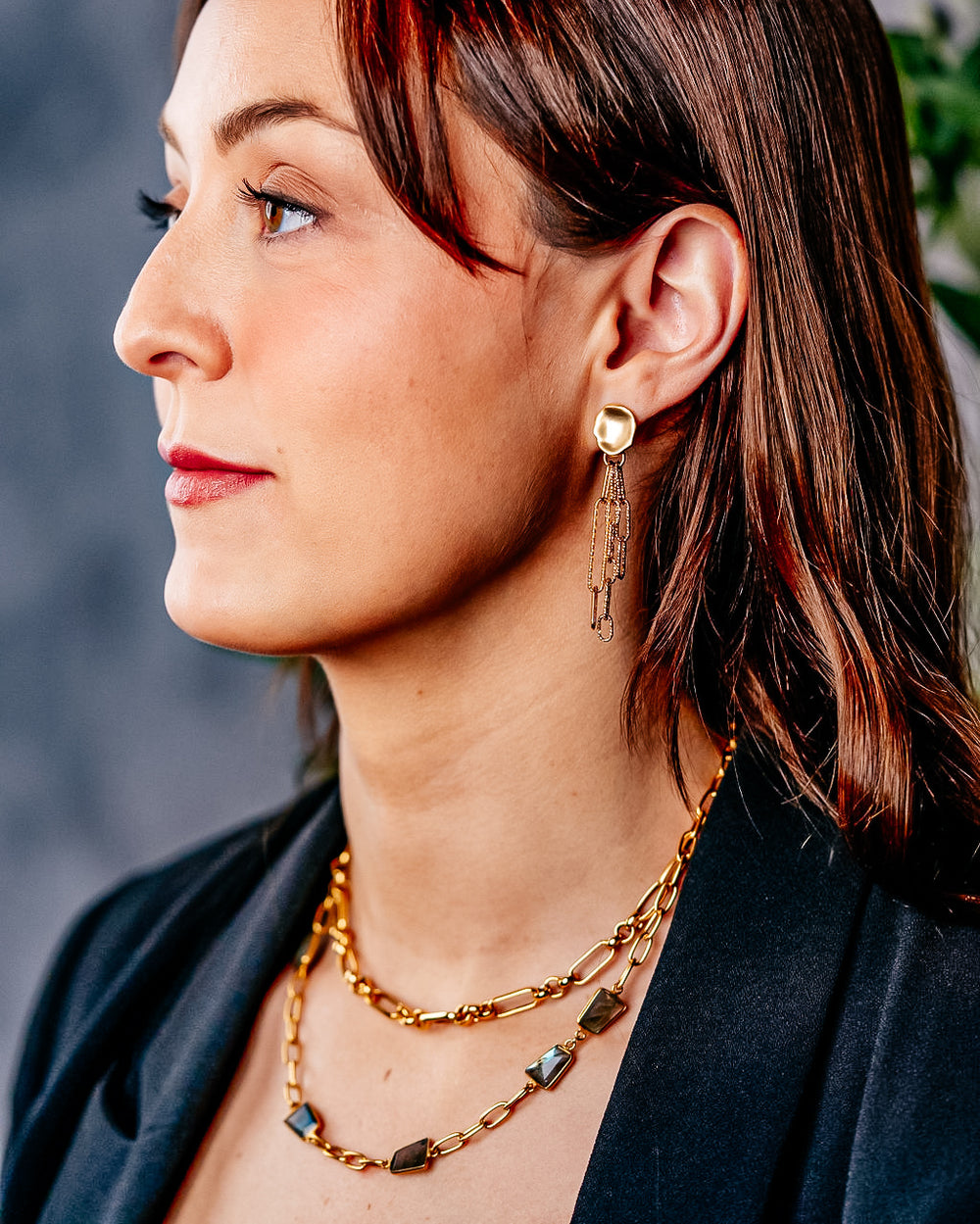 a model wearing an asymmetrical labradorite necklace