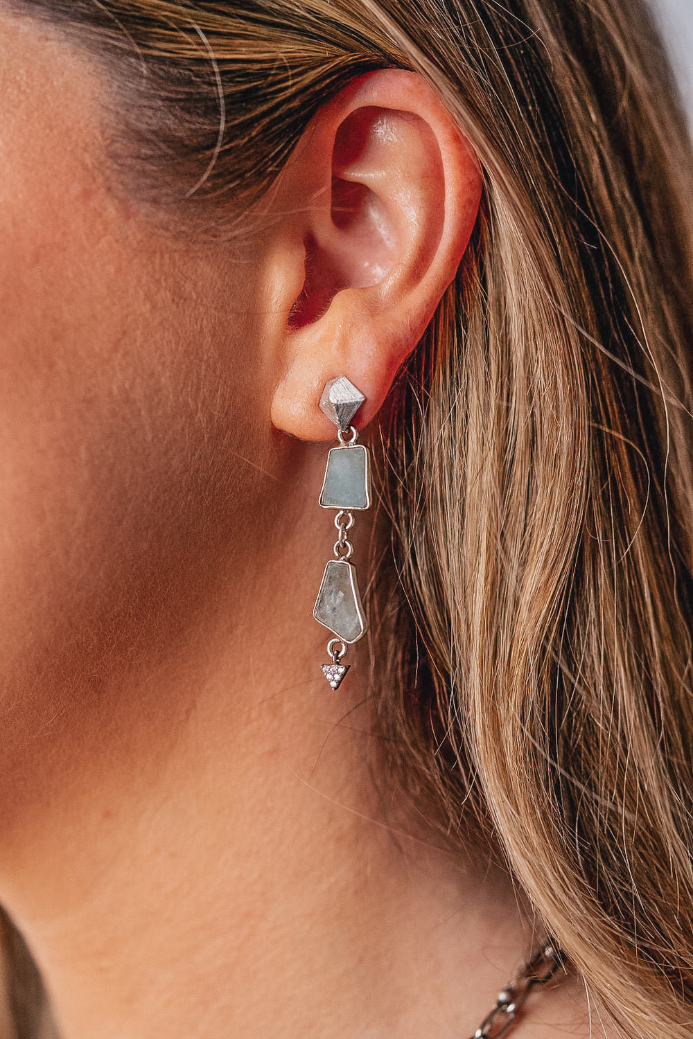 a model wearing Asymettrical aquamarine earrings.