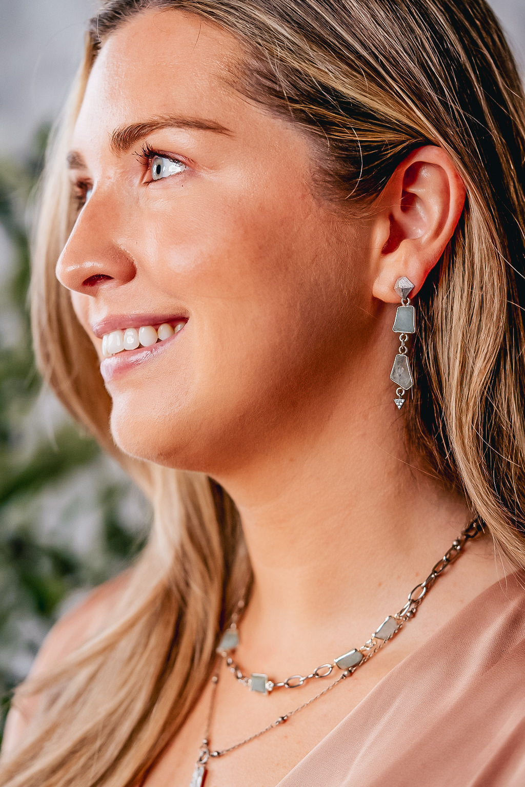 a model wearing Asymettrical aquamarine earrings.