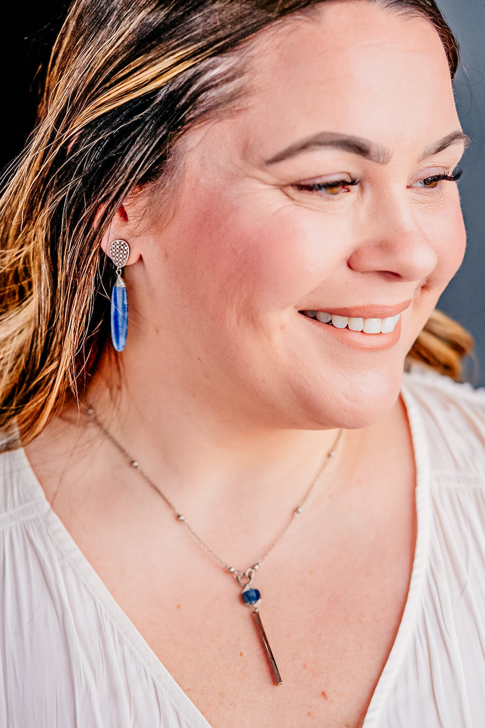 a model wearing a silver kyanite y necklace